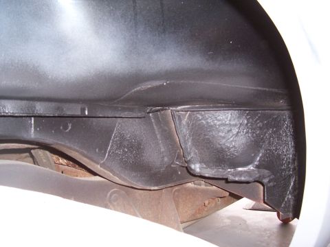 1978 Ford Bronco - Undercarriage view of a vehicle, focusing on the frame and wheel well structure.