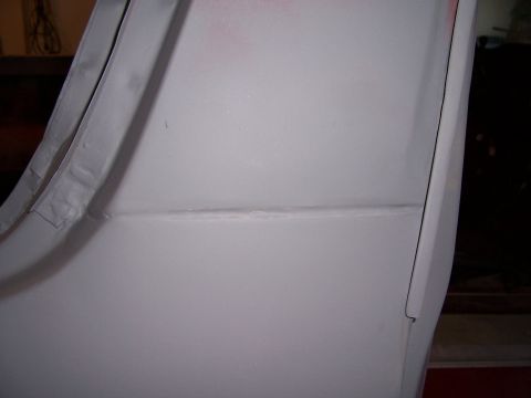 1978 Ford Bronco - A close-up view shows a seam on a vehicle's body panel, likely in primer before painting.