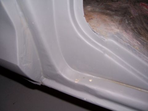 1978 Ford Bronco - Close-up of a vehicle's inner door jamb, showing primer and some rust. Supermotors.net watermark visible.