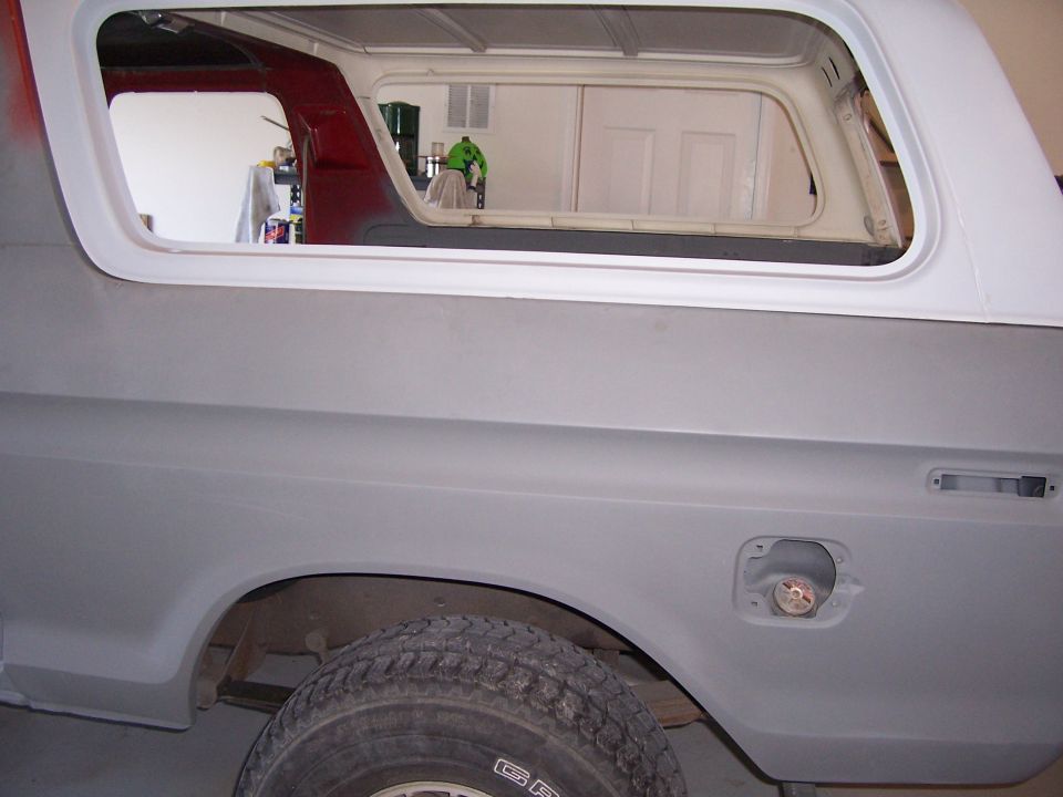 1978 Ford Bronco rear quarter panel with fuel door open, primer finish