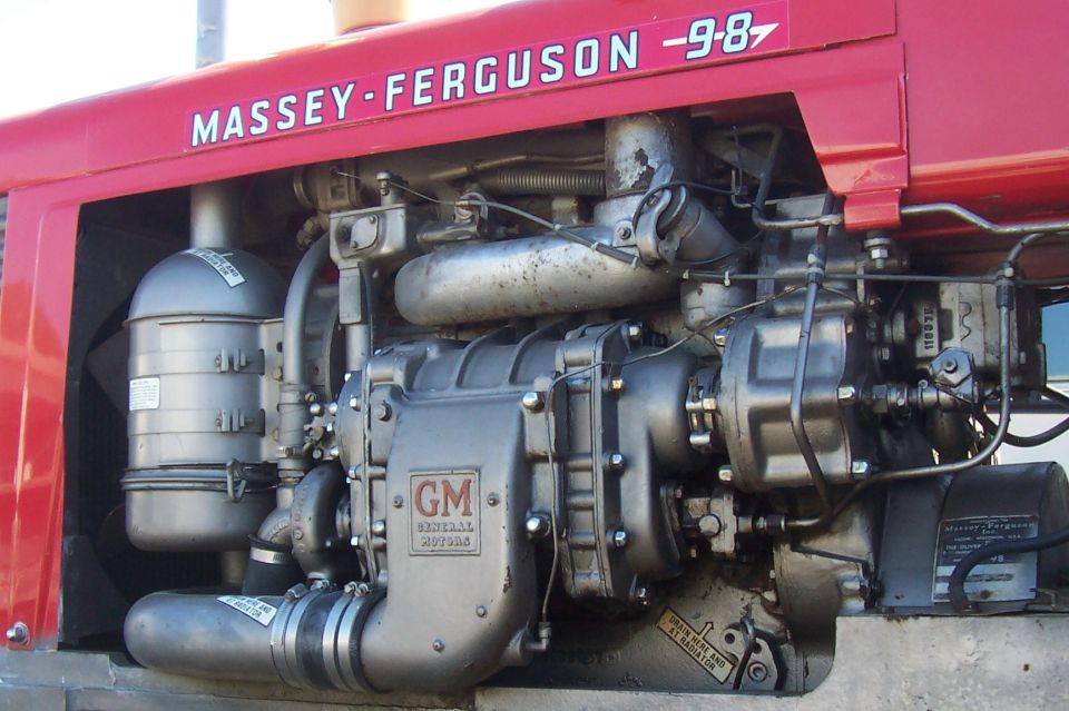 Red Massey-Ferguson tractor engine with GM components and air filter