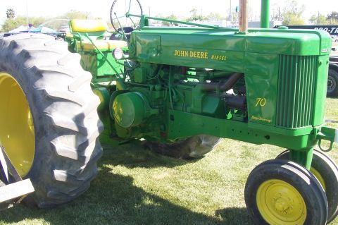 1994 Ford F-150 - A green John Deere tractor with prominent yellow wheels and seat is viewed from the front-right. The side displays 'JOHN DEERE DIESEL' and…