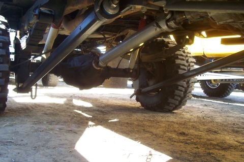 1994 Ford F-150 - Undercarriage view of a lifted truck with visible suspension and drivetrain parts.