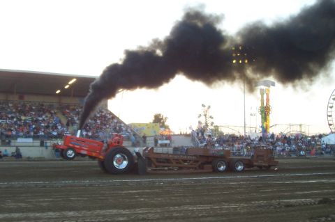 1994 Ford F-150 - Tractor pulling a sled at an event with a large crowd watching.