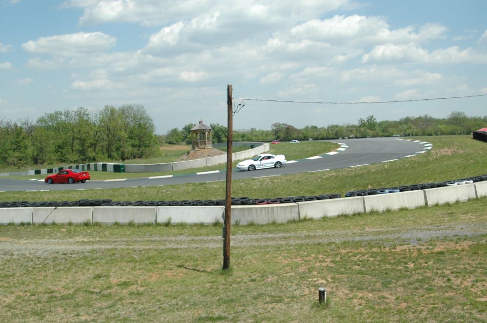 White 1993 Ford Mustang on race track, side view