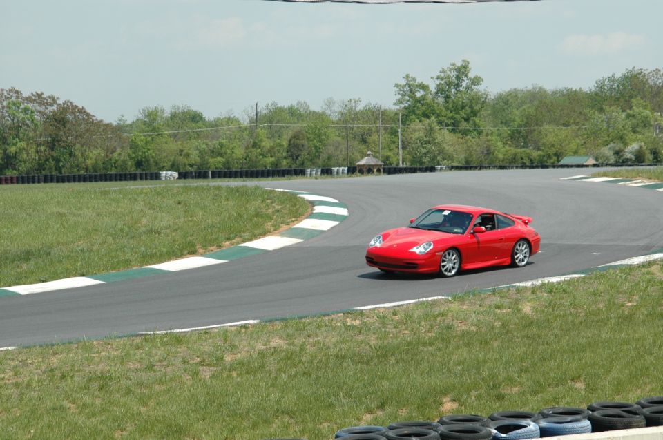 Red Porsche 911 on a race track, 3/4 front view
