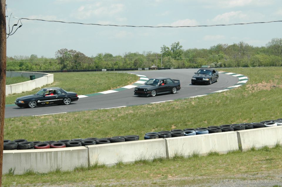 1993 Ford Mustang and two other cars on a race track