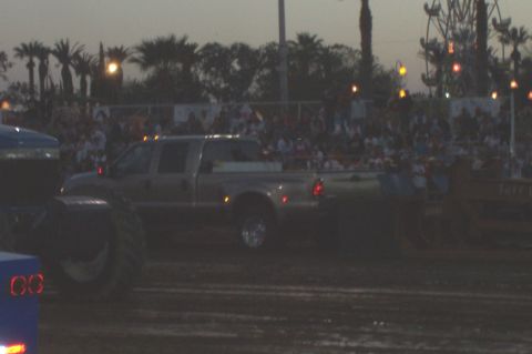 1994 Ford F-150 - A pickup truck is seen in a field with a large crowd watching.