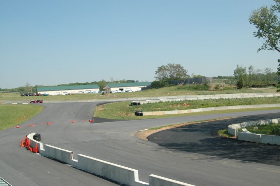 Race track with buildings and a few cars on the track