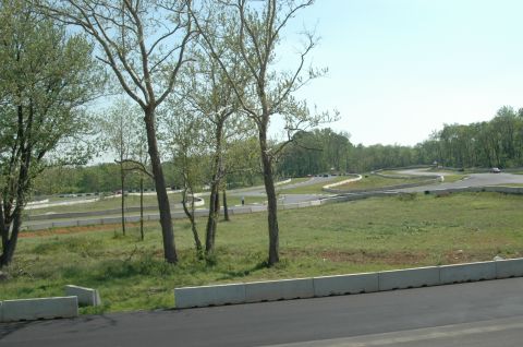 1993 Ford Mustang - A race track scene with trees and cars on the course.