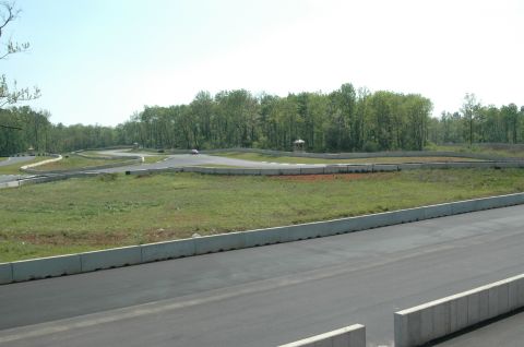 1993 Ford Mustang - A race track scene with a single car in the distance on a sunny day.