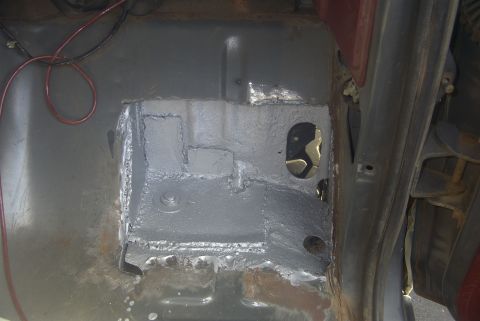 1994 Ford Bronco - Undercarriage repair work is visible, with patched metal and exposed wiring on the vehicle's frame.