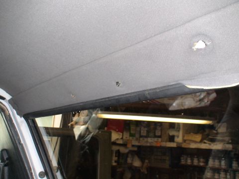 1993 Ford C-350 (Centurion Conversions) - The interior headliner shows signs of wear with multiple screw holes and a detached trim piece.