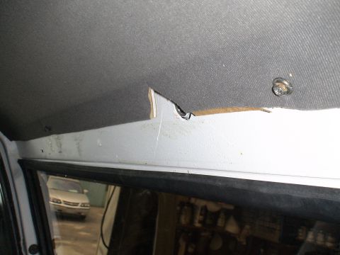 1993 Ford C-350 (Centurion Conversions) - Damage to the interior headliner and trim panel is visible, with another vehicle seen through the window.