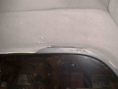 1993 Ford C-350 (Centurion Conversions) - Interior view of a vehicle's headliner and window, showing wear and tear.