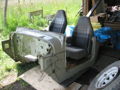 1991 Ford Explorer - Disassembled Jeep CJ-7 body tub and seats sit outdoors, awaiting restoration.