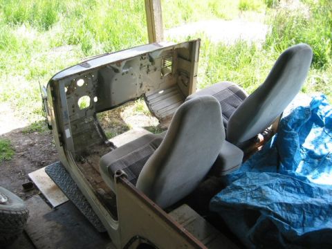 1991 Ford Explorer - Interior view of a Jeep CJ showing gray fabric seats and the vehicle's exposed metal framework.