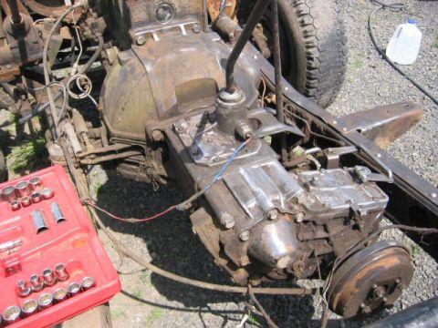 1991 Ford Explorer - Close-up of a vehicle's transmission and transfer case, with a red tool kit nearby.