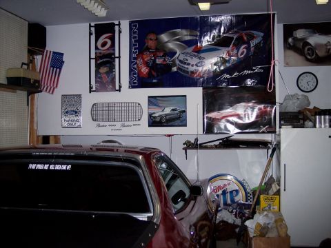 1972 Ford Ranchero - A 1972 Ford Ranchero is parked in a garage, surrounded by racing memorabilia and posters.