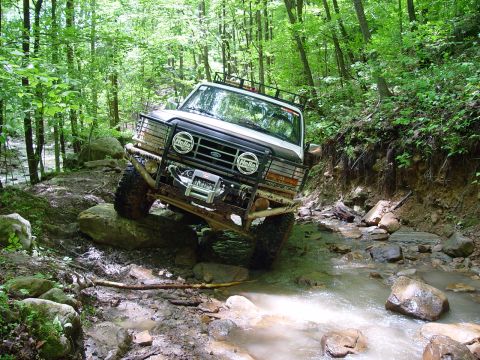 1996 Ford Bronco - This 1996 Ford Bronco tackles a challenging off-road course, with its front end angled towards a rocky stream bed.