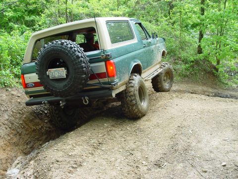 1996 Ford Bronco - This lifted Ford Bronco navigates a challenging off-road trail, its capabilities.