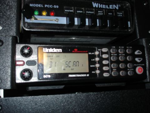 1999 Ford Crown Victoria - Close-up of a Uniden Trunktracker III police scanner and Whelen siren control panel.