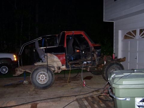 1979 Ford F-150 - A heavily modified truck sits in a driveway, undergoing apparent repairs or customization.
