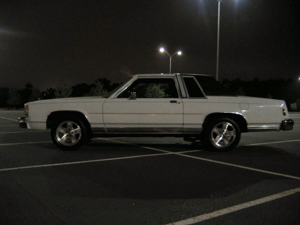 White 1985 Ford Crown Victoria parked at night