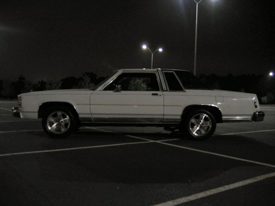 White 1985 Ford Crown Victoria LTD parked at night