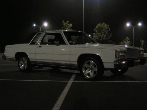 1985 Ford LTD Crown Victoria - This 1985 Ford Crown Victoria LTD is seen from the front three-quarter angle at night.