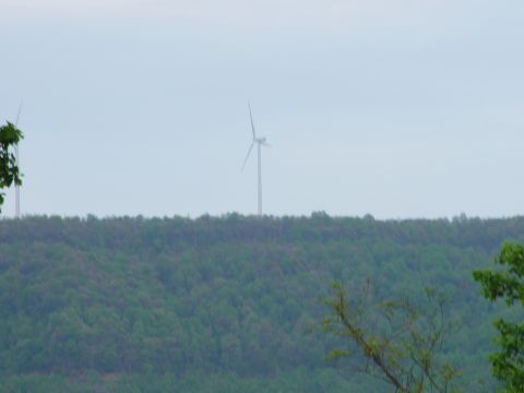 1996 Ford Bronco - Wind turbines are visible on a distant, tree-covered ridge.