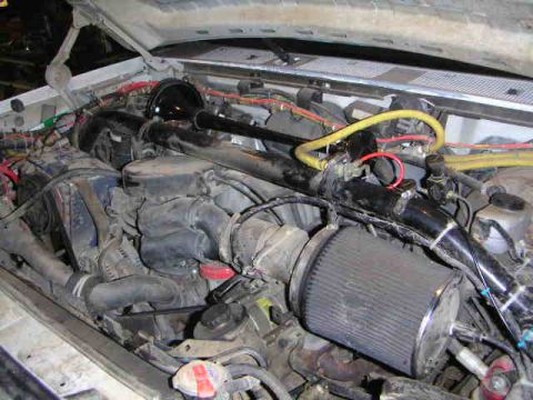 1996 Ford Bronco - Close-up view of a vehicle's engine bay, showing various components and wiring.