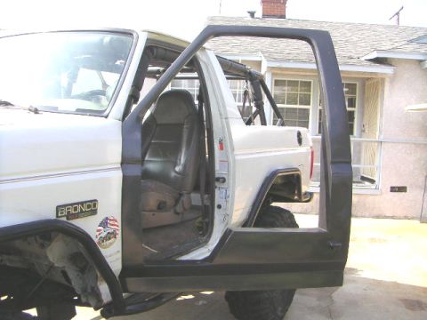 1996 Ford Bronco - This 1996 Ford Bronco shows its interior with the driver's door open, revealing a roll cage.