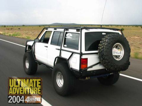 1996 Ford Bronco - This modified Jeep Cherokee XJ is equipped for off-road adventures, a full external roll cage and a spare tire mounted on the rear.