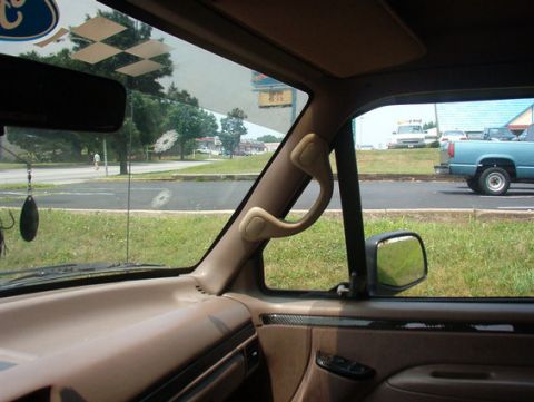 1996 Ford Bronco - Interior view of a 1996 Ford Bronco, with a blue pickup truck visible outside.