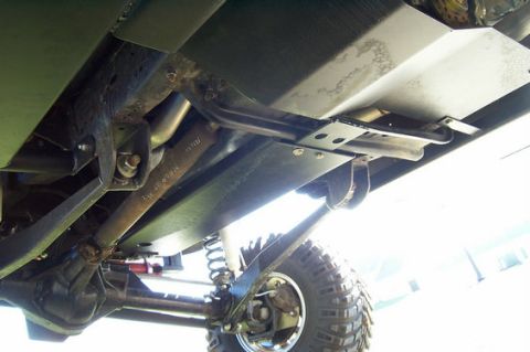 1996 Ford Bronco - Vehicle underbody with skid plates and suspension parts visible.