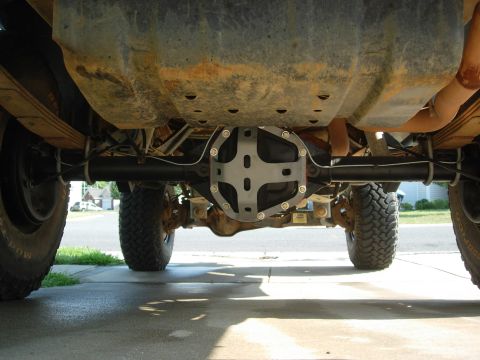1995 Ford Bronco - Underside view of a vehicle's rear axle, highlighting a custom differential cover and large off-road tires.