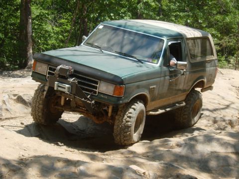 1995 Ford Bronco - This modified Ford Bronco navigates a challenging rocky terrain.