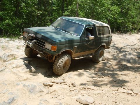 1995 Ford Bronco - This modified SUV navigates a challenging rocky trail, its off-road capabilities.