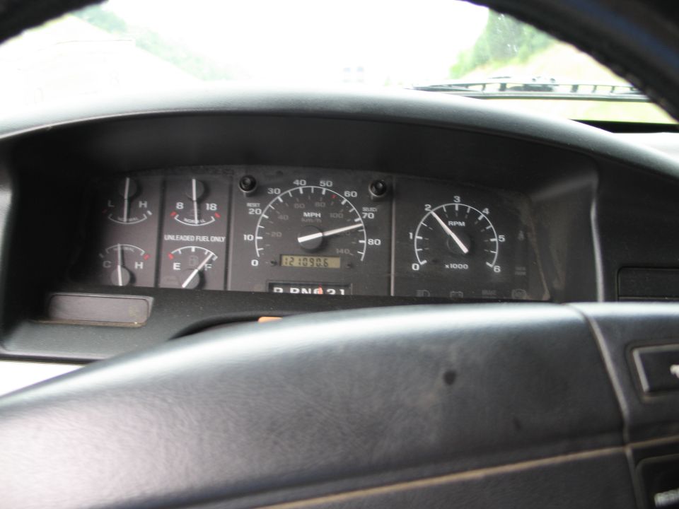 Dashboard with speedometer, tachometer, fuel gauge, and temperature gauge. Odometer reads 121095