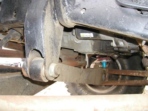 1984 Ford Bronco - Close-up view of the undercarriage and suspension system of a vehicle, with the Supermotors.net logo visible.