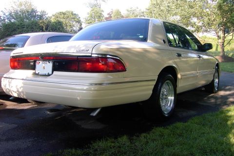 1996 Mercury Grand Marquis - Rear view of a 1996 Mercury Grand Marquis parked outdoors with another vehicle present.