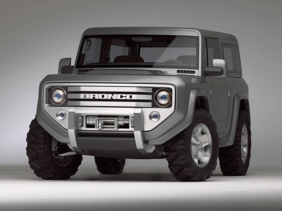 Silver boxy Ford Bronco concept SUV with BRONCO grille lettering and bumper winch, studio shot