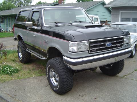 1989 Ford Bronco - This lifted Ford Bronco has a two-tone paint scheme and aggressive off-road tires.