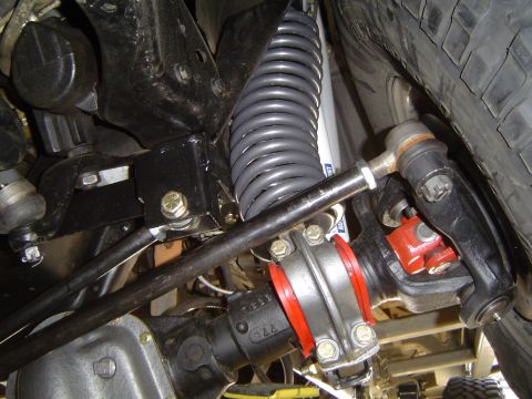 1989 Ford Bronco - Underneath view of Ford Bronco suspension system components, including a coil spring and shock absorber.