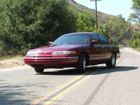 1992 Ford Crown Victoria - Maroon 1992 Ford Crown Victoria parked on a rural road.