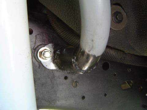 1989 Ford Bronco - Detail of a suspension component's mounting bracket, showing welding and hardware.