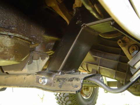 1989 Ford Bronco - Close-up view of the vehicle's undercarriage, highlighting modifications to the suspension system.