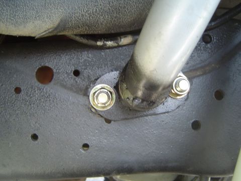 1989 Ford Bronco - This image shows a close-up view of a vehicle's frame with a suspension component and bolts.
