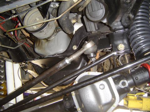 1989 Ford Bronco - Close-up view of the vehicle's undercarriage, focusing on suspension and drivetrain parts.